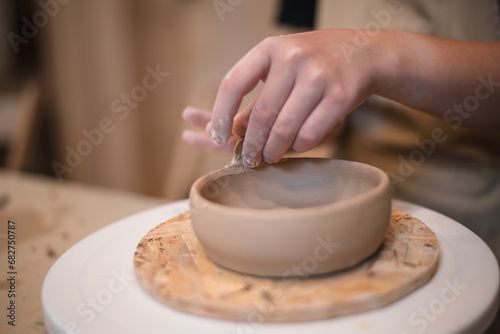 Woman hands, pottery studio and painting cup in workshop for sculpture, creative manufacturing or design. Painter, ceramics product and brush process, artistic pattern or production in small business