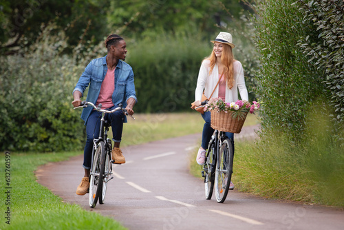 young couple is cycling in the forest