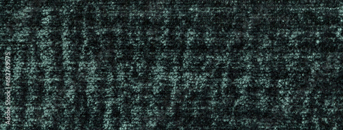 Texture of velvet dark green background from a soft upholstery textile material, macro. Abstract velour emerald fabric