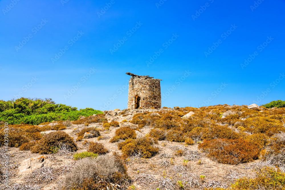 Landscape on the Greek island of Kos with a ruin of an old windmill.
