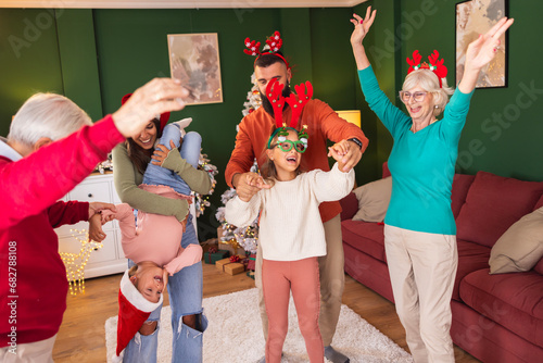 Multi-generation family having fun dancing while celebrating New Year at home