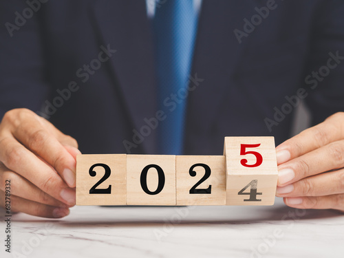 Flipping of 2024 to 2025 on wooden cubes for preparation of new year change.