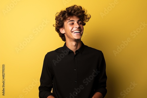 Teenage boy, Male employee wearing a black shirt yellow background