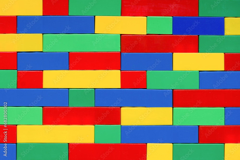 Wall from Colorful plastic brick blocks. Building with Educational Construction Toys. Education, children's creativity background