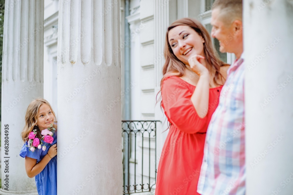 Concept of happy harmonious family. Dad, mom, daughter are enjoying day off, walking together. Concept of happy harmonious family. Dad, mom, daughter are enjoying day off, walking together.