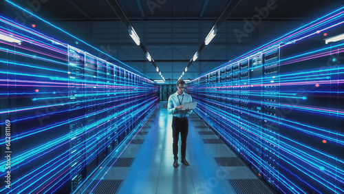 Cuadro en lienzo Futuristic Concept: Data Center Chief Technology Officer Holding Laptop, Standing In Warehouse, Information Digitalization Lines Streaming Through Servers
