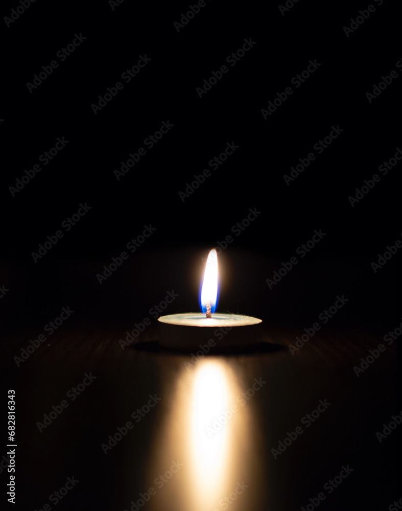 One candle light burning brightly in the black background. One candle light burning brightly in the black background.