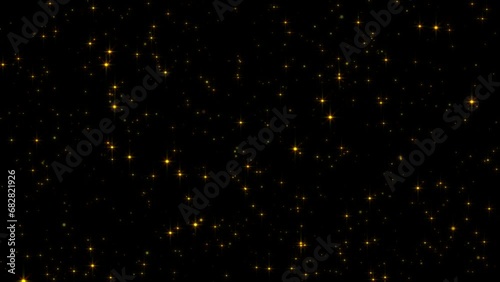 Glowing Star Particles flickering on black background photo