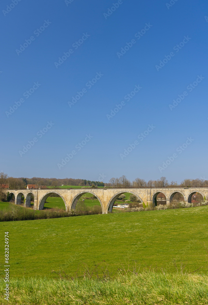 Arched stone railway bridge onabandoned railway near Cognieres, Doubs, France