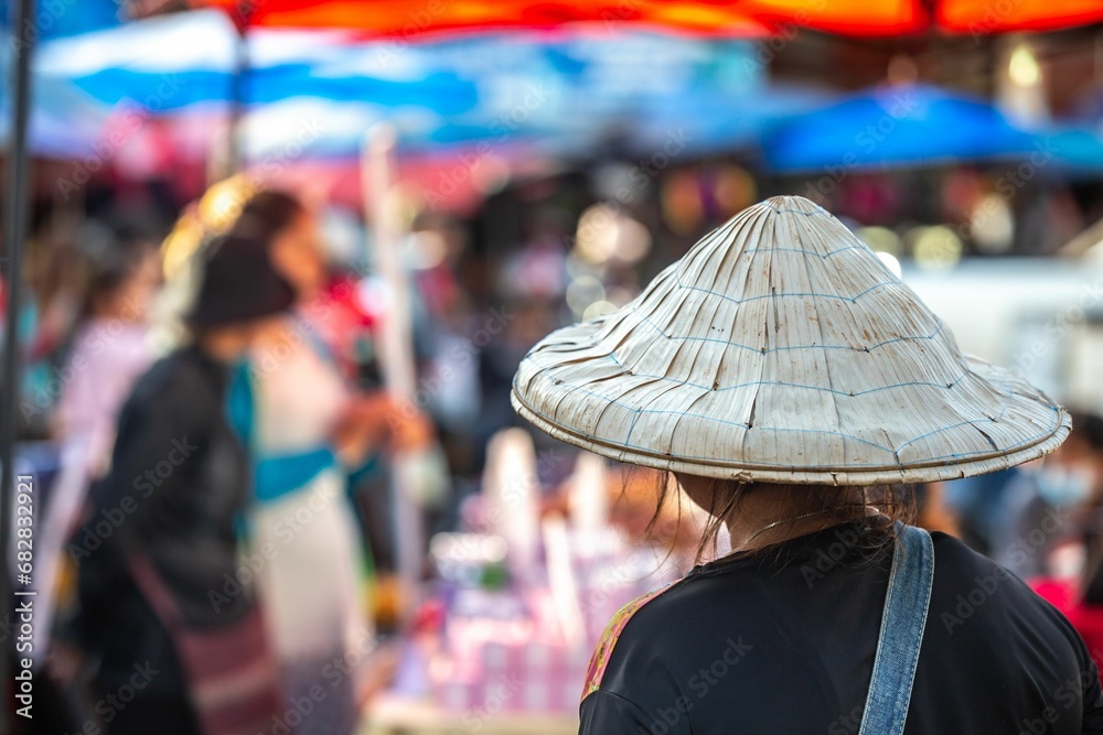 A photograph of an unidentified woman at the local market in Pakse, Laos.