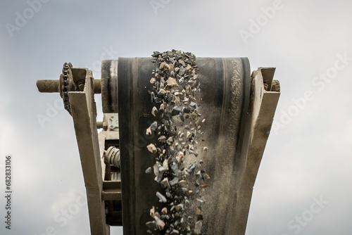 A photograph of the heavy machinery at the quarry, rocks and sand conveyor belt. photo