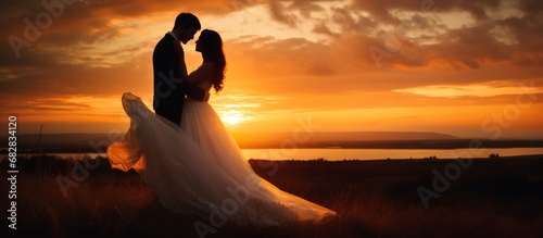 Wedding photography Beautiful bride and groom on the sunset lake background photo