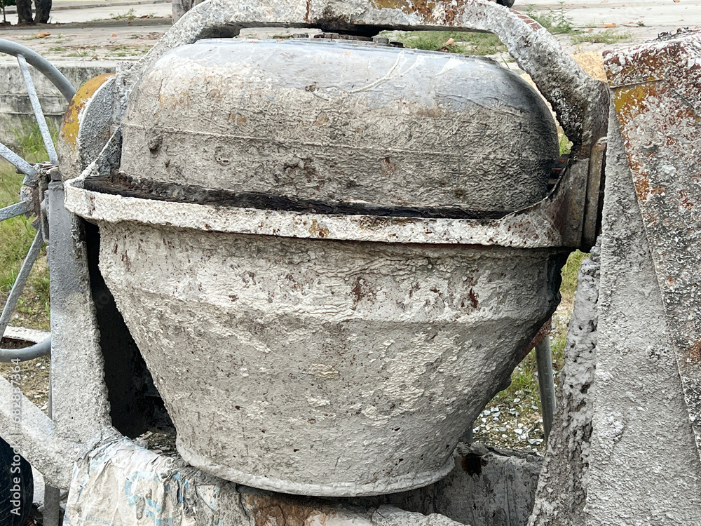 Fototapeta premium Cement mixer machine at construction site, tools and sand