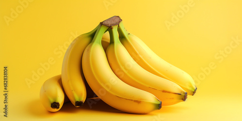 Several golden yellow bananas on a yellow background.