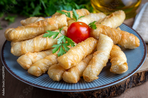 Obraz na płótnie Fried pastry wrapped in cheese in phyllo. Pie in the form of a roll. Turkish name; Kalem borek - sigara boregi w salonie