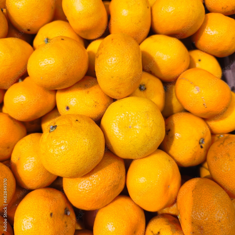 A bunch of oranges are piled together A bunch of oranges are piled together