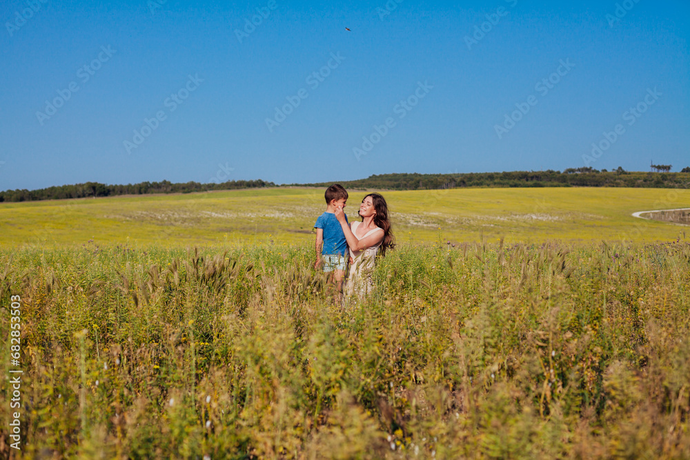 mother and son family on a walk in the field travel walk