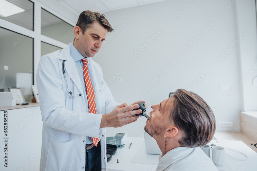 Experienced Doctors Performing Health Examinations on Young Patient in a Clinic Experienced Doctors Performing Health Examinations on Young Patient in a Clinic