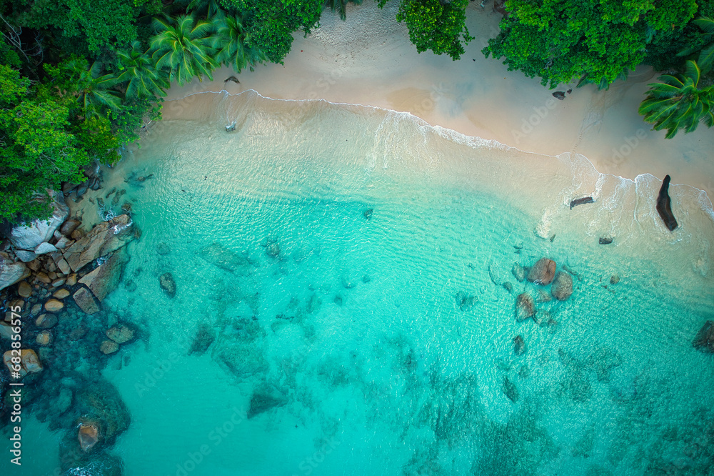 Bird eye drone shot of beautiful white sandy beach, turquoise water and granite stones, Mahe Seychelles 4
