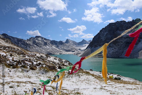 Ala-köl mountain lake with fresh snow during summer in Tian Shan mountains, Karakol, Kyrgyzstan photo