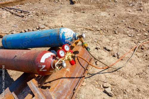 Metal gas acetylene cylinder containers with oxygen and nitrogen placed on the construction site.