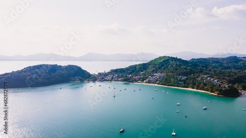 Aerial view of blue water surface background and sun reflection. aerial view of a flying drone Waves surface on a tropical ocean with bright sunlight. Perfect for vacations, in the island of Phuket 