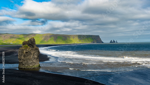 The Black Beach near Vik, Iceland, Arnardrangur or “Eagle Rock”, eagles nested there until 1850, Reynisfjara black sand beach created by lava flowing - Iceland, Europe