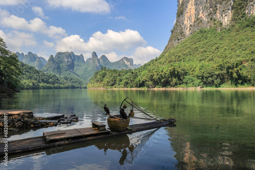 Leinwand Poster Landscape of karsten mountain along the Li River in Guilin with a bamboo raft an
