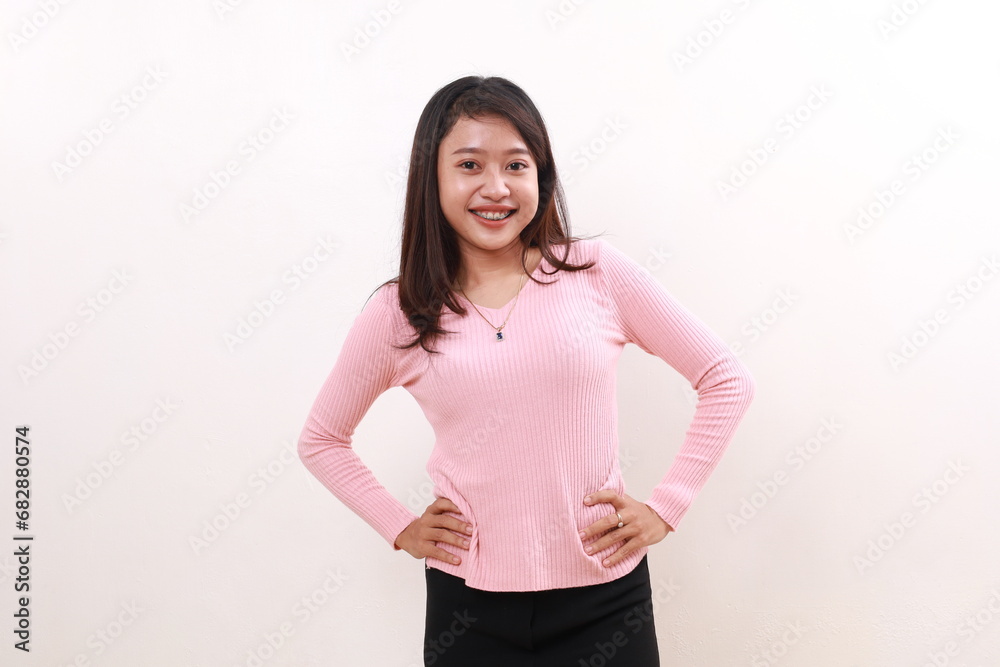 Confident young asian girl standing with hands on waist. Isolated on white background Confident young asian girl standing with hands on waist. Isolated on white background