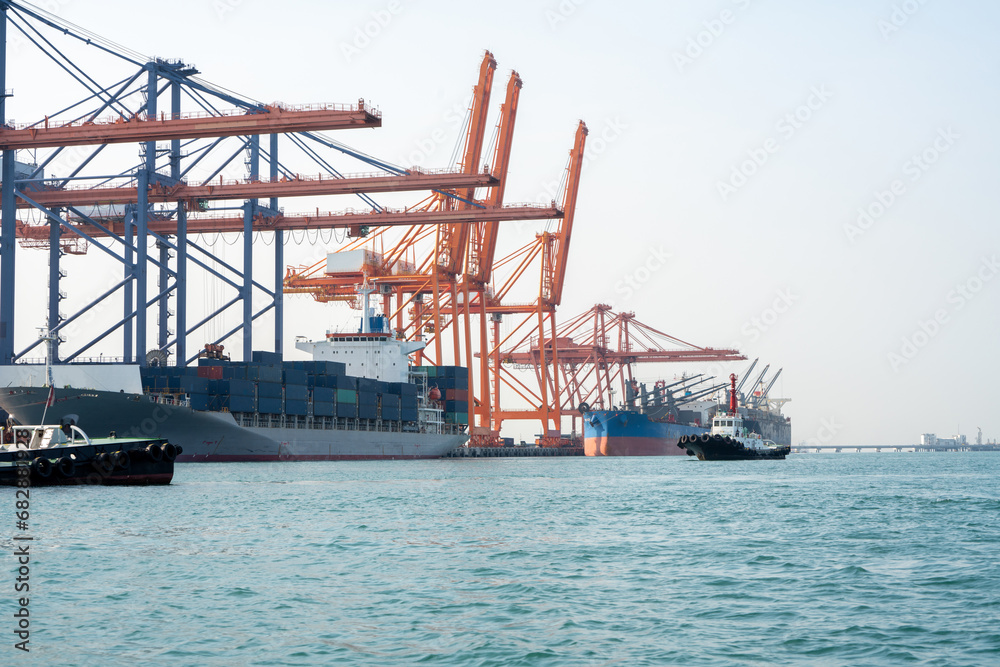 Big crane loading cargo container from truck to container ship in the international terminal logistic sea port concept freight shipping by ship, forwarder mast shipping