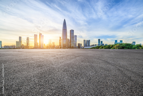 Asphalt road and urban skyline with modern buildings at sunset in Shenzhen, Guangdong Province, China. photo