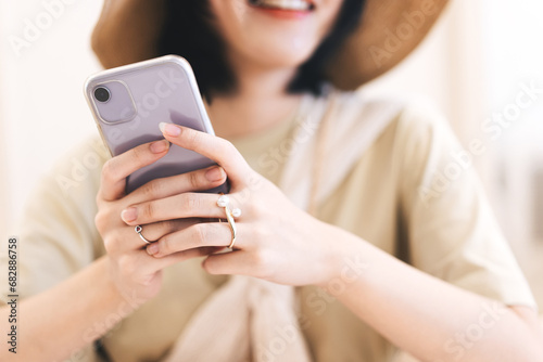 Closedup woman hand typing message with smartphone in quiet luxury beige fashion modern lifestyles photo