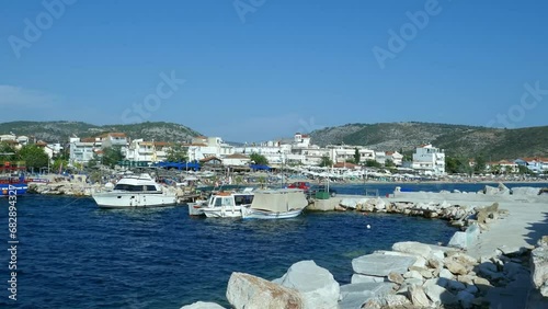 Potos is a tourist attraction in southern part of the Thassos Island , Greece , seen here from the pier , the fisherman boats , specific architecture and the blue Aegean sea , sunny summer day. photo