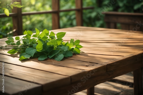empty wooden table with green foliage in sunlight background