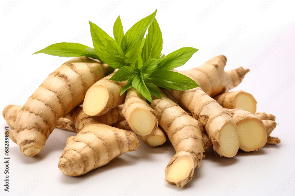 Fresh ginger rhizome with sliced and green leaves isolated on white background.. Fresh ginger rhizome with sliced and green leaves isolated on white background..