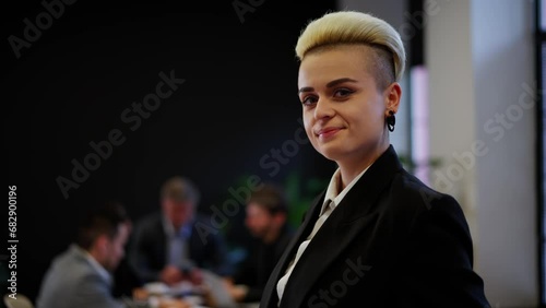 Young businesswoman cheerful wear formal suit posing on team brainstorming background. Girl first day in office internship. Lady targetologist member of ceo meeting. photo