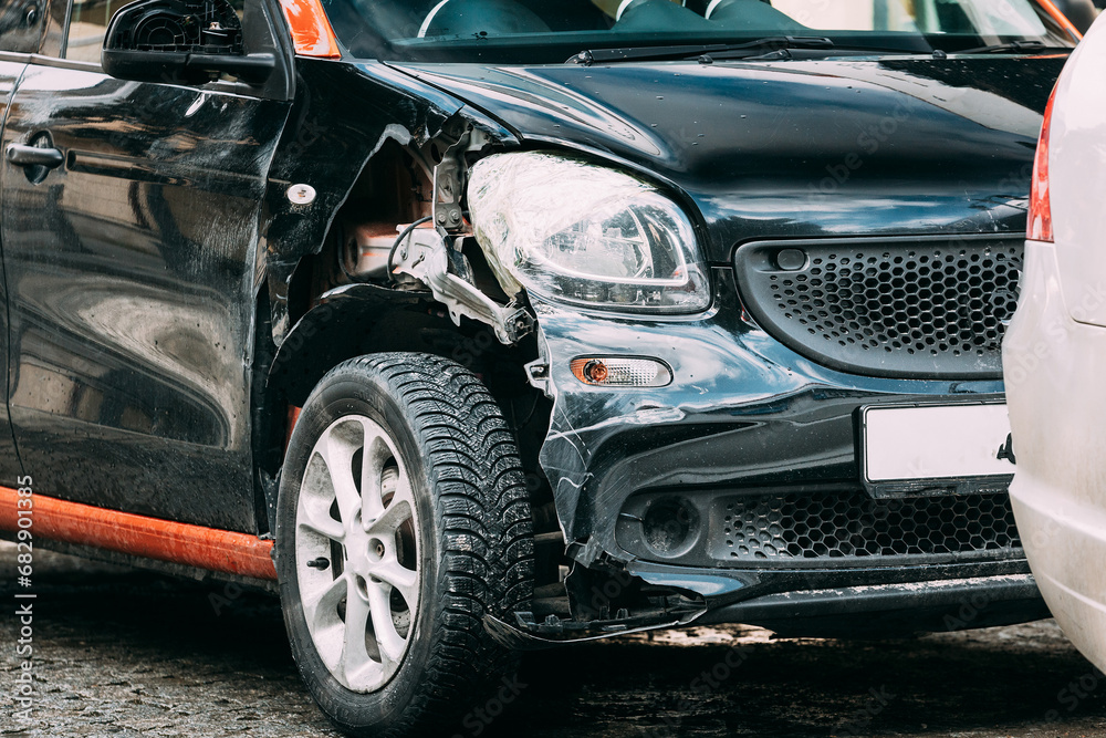 Broken Scratched And Dent Bumper Fender on small luxury Car after Collision. Scratched With Deep Damage To Paint. Crashed car parked on City Street. Car Wreck, Accident. dent and damage on the car