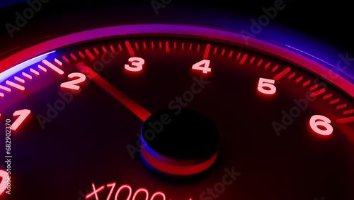 Shaking neon tachometer close up with arrow showing fast increasing rotation speed of the engine and decreasing speed while the gear shift. CGI motion design on a dark background. 3D animation photo