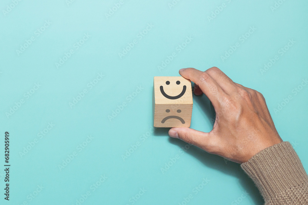 Hand flip wooden cube change smile face emoticon give a five star rating with rating feedback scale. Concept of service rating, satisfaction and feedback - obrazy, fototapety, plakaty 