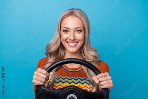 Photo of shiny pretty lady wear print shirt smiling enjoying driving car isolated blue color background