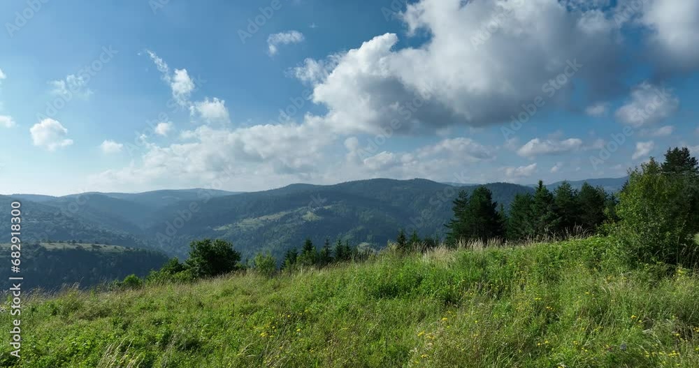 Aerial view of mountain peaks and fresh green grass on a sunny summer day Aerial view of mountain peaks and fresh green grass on a sunny summer day