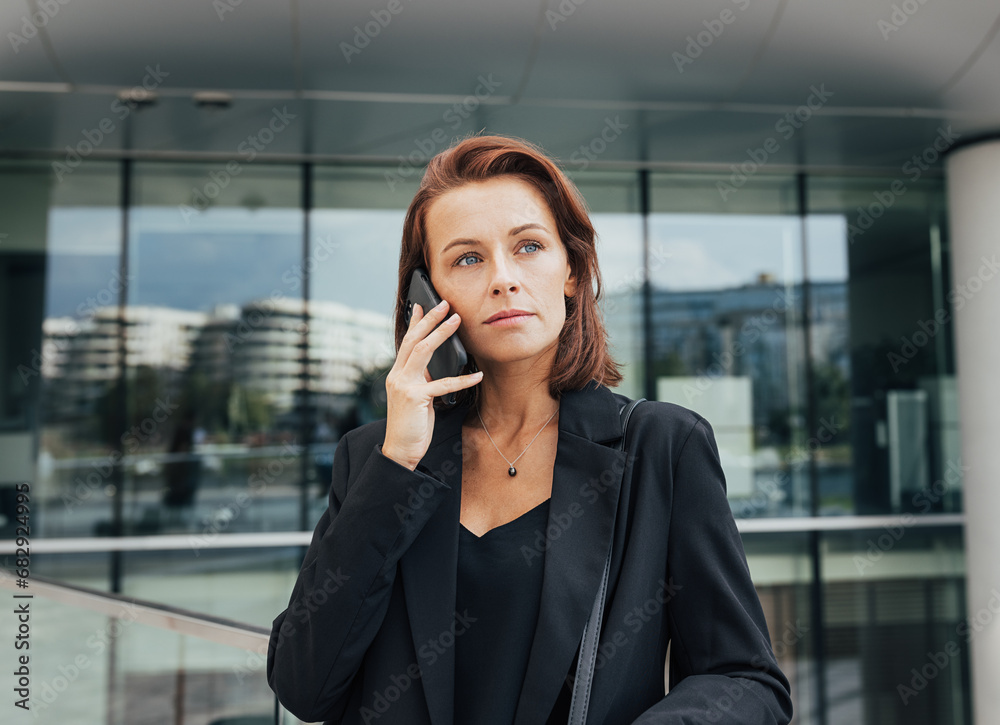 Portrait of a middle-aged female with ginger hair making a phone call Portrait of a middle-aged female with ginger hair making a phone call