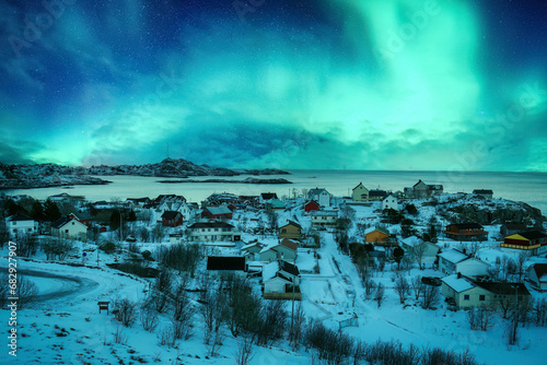 Aurora borealis over snowy A nordland village of Moskenes at Lofoten Islands, Norway photo