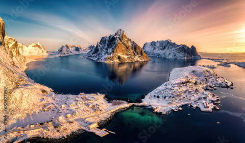 Colorful sunrise over Lofoten Islands and traditional norwegian fishing village in winter at Norway © Mumemories