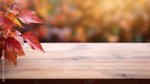Empty wooden table top, bathed in warm autumnal hues, with a beautifully blurred background showcasing the exuberant colors of the season photo
