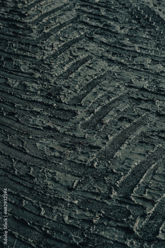 dark muddy road background with tire traces, dirty ground