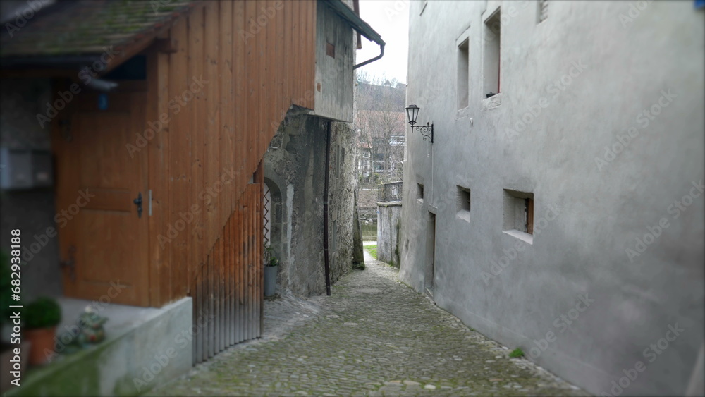 Empty Narrow European ancient street in Switzerland. Traditional cobblestone and buildings