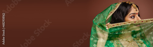 Φωτογραφία beautiful indian woman with long hair and bindi dot covering her face with green
