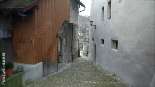 Empty Narrow European ancient street in Switzerland. Traditional cobblestone and buildings © Marco