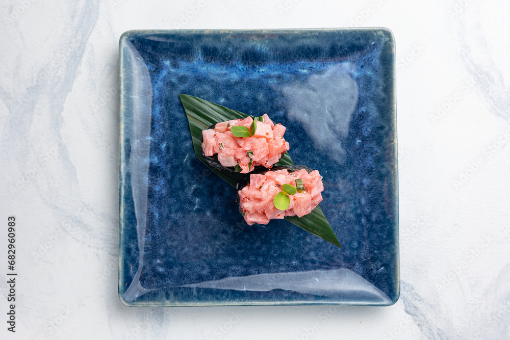 Japanese cuisine. Gunkan on blue plates
Japanese cuisine. Gunkan on blue plates
